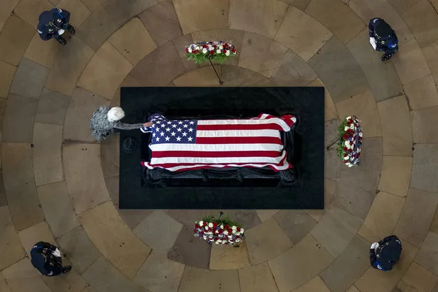 Landra Reid touches the casket of her husband, former Sen. Harry Reid, D-Nev., as he lies in state in the Rotunda of the U.S. Capitol, Wednesday, January 12, 2022, in Washington. (Photo by Andrew Harnik/AP Photo/Pool)