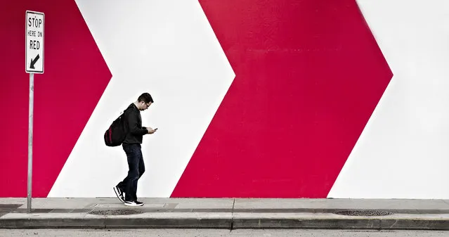 “Stop on Red”. A man walks in front of the San Francisco MoMa. Walking in white, not stopping on red...no sense of place, no sense of time. Photo location: San Francisco. (Photo and caption by Iris van den Broek/National Geographic Photo Contest)