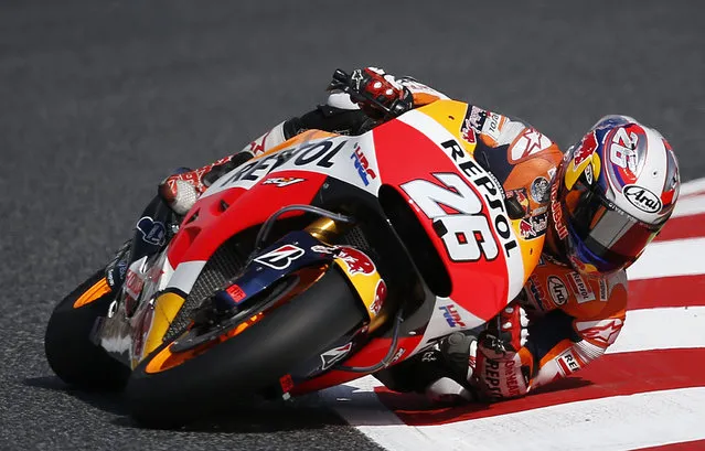 Spanish Moto GP rider Dani Pedrosa steers his bike during the free practice for the motorcycle GP in Montmelo, Spain, Saturday, June 13, 2015. The Catalunya Grand Prix will take place on Sunday in Montmelo. (AP Photo/Manu Fernandez)