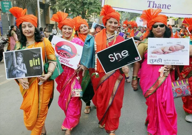 Women dressed in traditional Marathi attires, with placards displaying a message to save girl child, as they walk on streets during “Shobha Yatra”, to celebrate the Hindu new year “Gudi Padwa”, in Thane, India on Tuesday, March 28, 2017. (Photo by Press Trust of India)