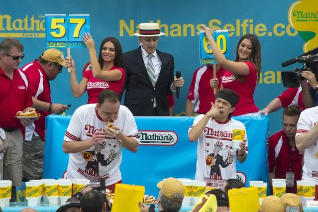 Joey Chestnut (L) and Matt Stonie (R) consume hot dogs during the annual Fourth of July 2015 Nathan's Famous Hot Dog Eating Contest in Brooklyn, New York July 4, 2015. (Photo by Andrew Kelly/Reuters)