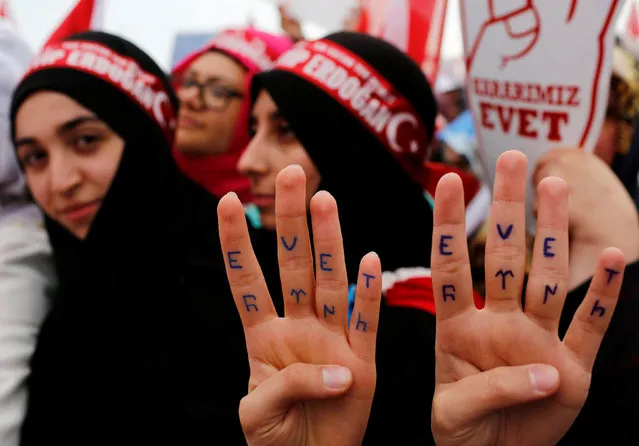 Supporters of Turkish President Tayyip Erdogan show their hands with “Yes” inscription during a rally for the upcoming referendum in Istanbul, Turkey, April 8, 2017. (Photo by Murad Sezer/Reuters)