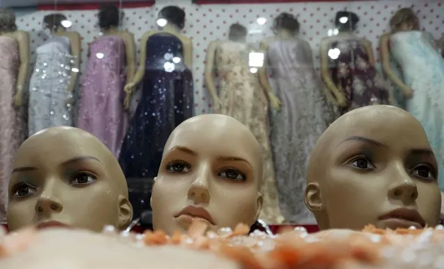 The heads of mannequins (foreground) are seen at a at a women's clothing store in Herat on January 5, 2022. The Taliban have ordered shop owners in western Afghanistan to cut the heads off mannequins, insisting figures representing the human form violate Islamic law. (Photo by AFP Photo/Stringer)