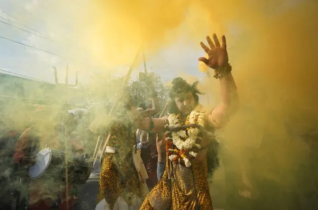 A devotee dressed as Hindu god Shiva participates in a procession on the eve of Shivratri festival, in Jammu, India, Monday, February 28, 2022. The festival dedicated to the worship of Shiva, will be marked across the country on Tuesday. (Photo by Channi Anand/AP Photo)