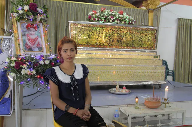 Chiranut Trairat, mother of an 11-month-old baby girl, sits in front of her daughter's coffin at Si Sunthon temple in Phuket, Thailand, Wednesday, April 26, 2017. Her husband upset with her hanged their daughter on Facebook Live and then killed himself, police said. (Photo by AP Photo/Stringer)