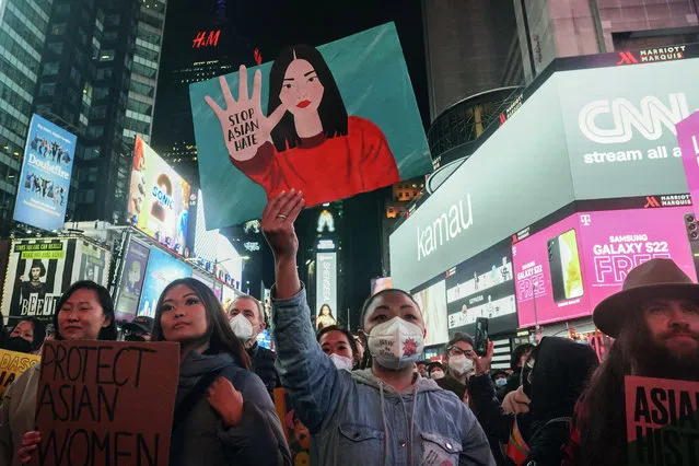 Members and supporters of Asian American and Pacific Islander communities hold a rally to acknowledge the one year anniversary of the Atlanta spa shootings, Wednesday March 16, 2022, in New York. (Photo by Bebeto Matthews/AP Photo)