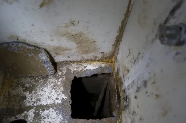 A view of the opening of a tunnel, which is connected to a warehouse, inside drug lord Joaquin “El Chapo” Guzman's cell in the Altiplano Federal Penitentiary, where he escaped from, in Almoloya de Juarez, on the outskirts of Mexico City, July 15, 2015. (Photo by Edgard Garrido/Reuters)