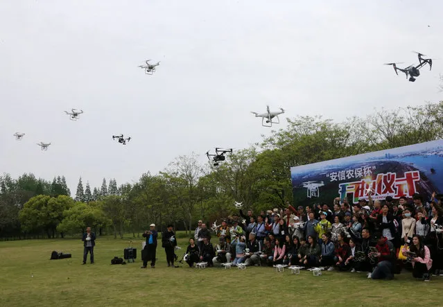 People fly drones during the launch ceremony of an aerial photography contest held in Shanghai, China April 26, 2017. (Photo by Reuters/Stringer)