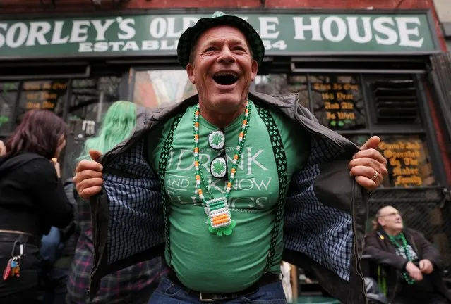 A man celebrates St. Patrick's Day at McSorely’s Old Ale House, in the Manhattan borough of New York City, New York, U.S., March 17, 2022. (Photo by Andrew Kelly/Reuters)