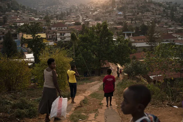 In this September 9, 2019 photo, people walk on a hilly street as the sun sets in Kigali, Rwanda. An estimated 60 million people in the world will die this year, and half will lack death certificates – and so have no recorded cause of death. Most will be in low- and middle-income countries, particularly in Africa and parts of Asia. (Photo by Felipe Dana/AP Photo)