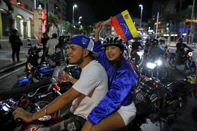 Supporters of President Nicolas Maduro celebrate after electoral authorities declared him the winner of the presidential election in Caracas, Venezuela, Monday, July 29, 2024. Venezuela, Monday, July 29, 2024. (Photo by Cristian Hernandez/AP Photo)