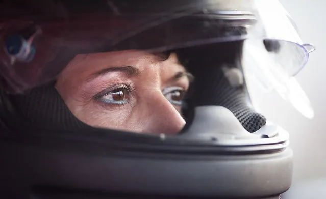 In this July 17, 2015 photo, Melanie Denny watches other drivers as she waits to take to the track for a qualifying round at the Ponderosa Speedway in Junction City, Ky. Melanie was one of three women behind the wheel of race cars Friday night and has a crew made up of her husband and father. (Photo by David Stephenson/AP Photo)