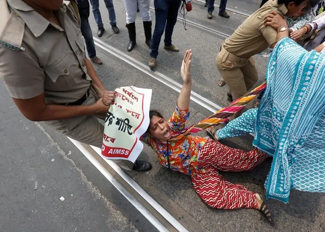 Police detains an activist of the Socialist Unity Centre of India (SUCI) during a protest against the recent gang-rape of a woman in a moving car, according to local media, in Kolkata, India May 31, 2016. (Photo by Rupak De Chowdhuri/Reuters)