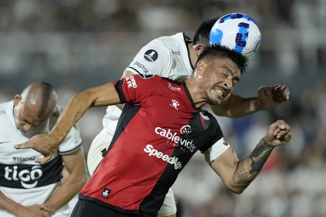 Paolo Goltz of Argentina's Colon de Santa Fe, front, and Saul Salcedo of Paraguay's Olimpia, back, go for a header during a Copa Libertadores soccer match at Defensores del Chaco stadium in Asuncion, Paraguay, Thursday, April 28, 2022. (Photo by Jorge Saenz/AP Photo)