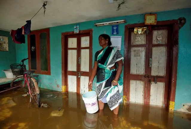 A woman prepares to remove rainwater from her house after heavy rains in Chennai, India, December 2, 2019. (Photo by P. Ravikumar/Reuters)