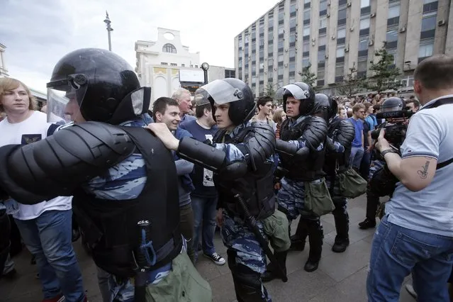 Russian police officers block participants of an unauthorized opposition rally in Tverskaya street in central Moscow, Russia, on Russia Day, 12 June 2017. Russian liberal opposition leader and anti-corruption blogger Alexei Navalny has called his supporters to hold a protest in Tverskaya Street, which leads to the Kremlin, instead of the authorized by Moscow officials Sakharov avenue. Changing the location may provoke clashes with the police. (Photo by Sergei Chirikov/EPA)