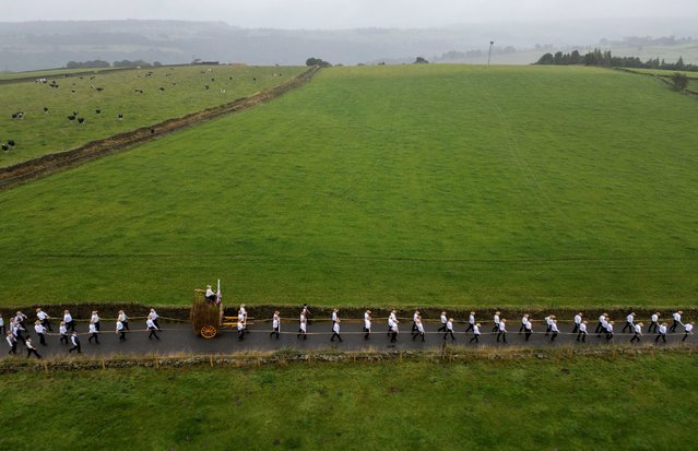 A drone view shows locals wearing straw hats pull a cart carrying reeds through the village during the annual “rushbearing” festival in Sowerby Bridge, Britain, on September 8, 2024. (Photo by Phil Noble/Reuters)