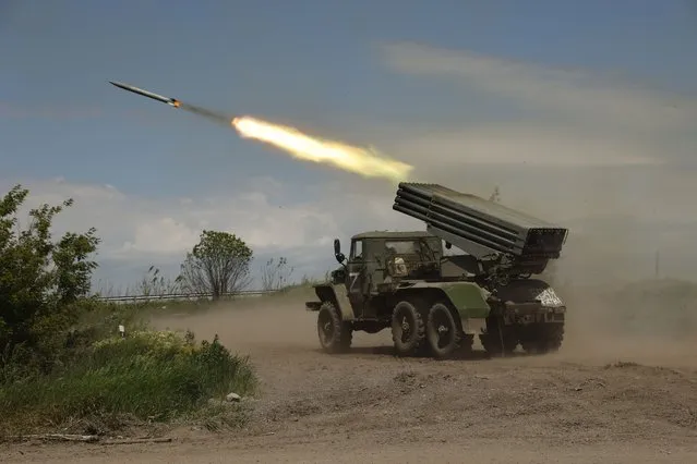A Donetsk People's Republic militia's multiple rocket launcher fires from its position not far from Panteleimonivka, in territory under the government of the Donetsk People's Republic, eastern Ukraine, Saturday, May 28, 2022. (Photo by Alexei Alexandrov/AP Photo)