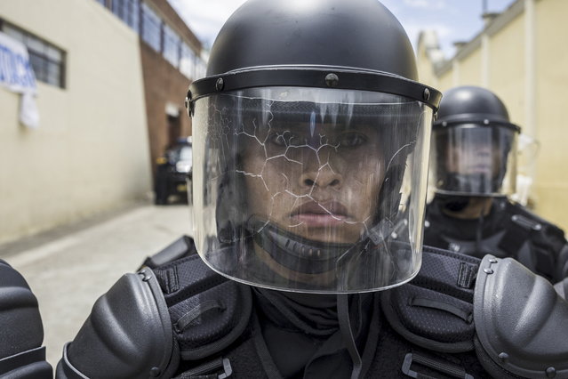 Police officers cordon off the polling center of San Jose del Golfo, where prosecutors and residents tried to prevent voting after accusing the current mayor of carrying people to vote for him, in the department of Guatemala, Guatemala, 25 June 2023. At midday security forces had to remove the ballots under a strong contingent of police agents, and the local election was suspended. 9.3 million people are authorized by the Supreme Electoral Tribunal (TSE) to cast their vote in Guatemala's general elections. (Photo by Esteban Biba/EPA)