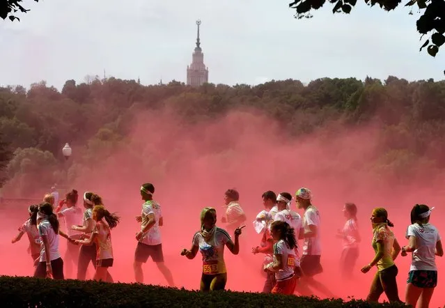 People participate in the “Colour Run 2016” at the Luzhniki Olympic Complex in Moscow on June 19, 2016. The Colour Run is a five kilometres paint race without winners nor prizes, while runners are showered with colored powder at stations along the run. (Photo by Vasily Maximov/AFP Photo)
