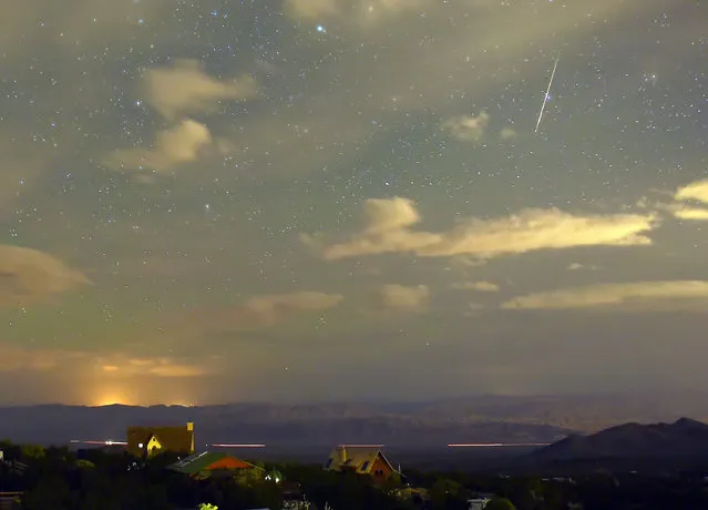 A Perseid meteor streaks across the sky over the community of Cold Creek on August 12, 2015 in the Spring Mountains National Recreation Area, Nevada. The annual display, known as the Perseid shower because the meteors appear to radiate from the constellation Perseus in the northeastern sky, is a result of Earth's orbit passing through debris from the comet Swift-Tuttle. (Photo by Ethan Miller/Getty Images)