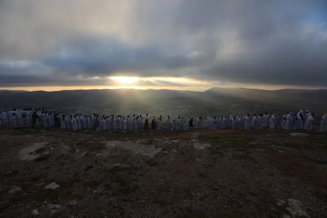 Members of the Samaritan community attend a religious service marking the end of their Passover holiday atop Mount Gerizim, above the West Bank city of Nablus, 21 April 2022. According to tradition, the Samaritans are descendants of the Jews who were not deported when the Assyrians conquered Israel in 722 BC. The small community numbers about 810 people, half of them live in a village at Mount Gerizim, near the Palestinian city of Nablus, and the rest in Holon near Tel Aviv in Israel. (Photo by Alaa Badarneh/EPA/EFE)