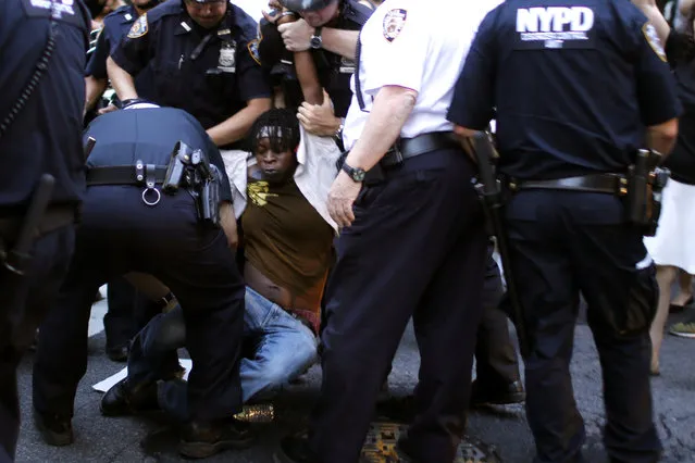 A protestor is detained by NYPD officer as people take part in a protest for the killing of Alton Sterling and Philando Castile during a march along Manhattan's streets in New York July 7, 2016. (Photo by Eduardo Munoz/Reuters)