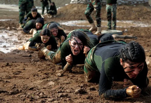 Members of Kurdish Peshmerga Special Forces demonstrate their skills during their graduation ceremony at a military camp in Soran district, in Erbil province, Iraq on February 12, 2020. (Photo by Azad Lashkari/Reuters)