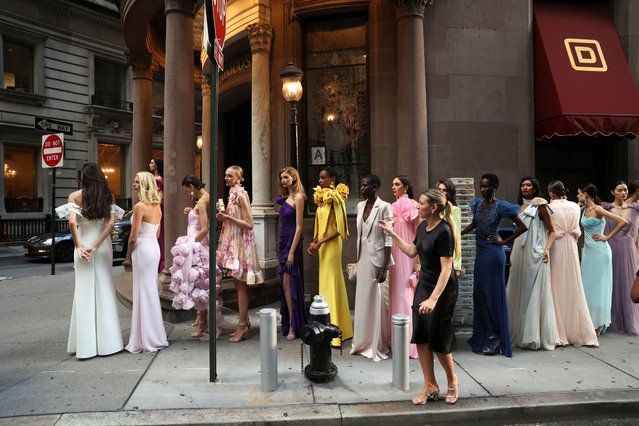 Models wait to be photographed in Lower Manhattan, with creations by Badgley Mischka during New York Fashion Week, in New York City, U.S., September 13, 2023. (Photo by Caitlin Ochs/Reuters)