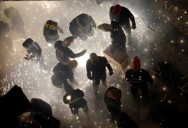 Revellers play with fireworks during the annual “Corda” festival in the village of Paterna near Valencia, Spain, August 28, 2017. (Photo by Heino Kalis/Reuters)