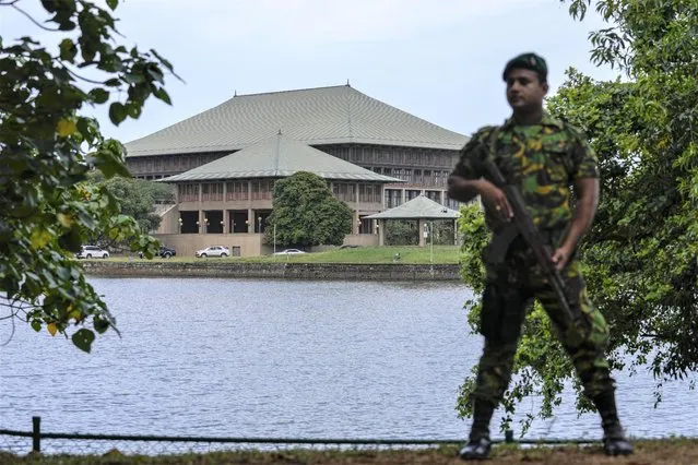 An army soldier soldier stands guard outside the parliament building in Colombo, Sri Lanka, Saturday, July 16, 2022. (Photo by Rafiq Maqbool/AP Photo)