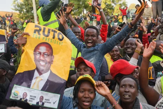 Supporters of William Ruto, Kenya's President elect, celebrate in Eldoret on August 15, 2022. The head of Kenya's election body on August 15, 2022 declared Deputy President William Ruto the winner of the country's close-fought presidential election, despite several commissioners rejecting the results. Independent Electoral and Boundaries Commission chairman Wafula Chebukati said Ruto had won almost 7.18 million votes (50.49 percent) against 6.94 million (48.85 percent) for his rival Raila Odinga in the August 9 vote. (Photo by Simon Maina/AFP Photo)