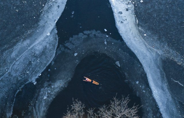 A retired elderly man braved the cold weather to swim in the frozen lake in the park on December 12, 2024 in Shenyang City, Liaoning Province, China. The benefits of winter swimming to the body are believed to be, the enhancement of the bodies immune system and benefit to the cardiovascular function aswell as too the mental health and stress levels. (Photo by Weitao Tian/Getty Images)