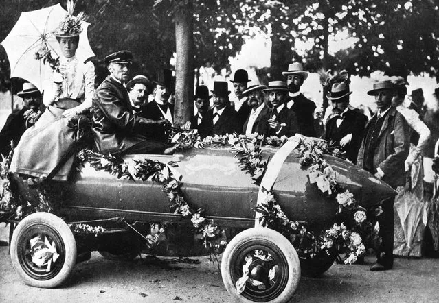 Laurels for Camille Jenatzy (in driver's seat), the first man to exceed 100 kph (62 mph) at Acheres, near Paris. The car, christened “Jamais Contente”, was an electric vehicle of his own design, 1899.