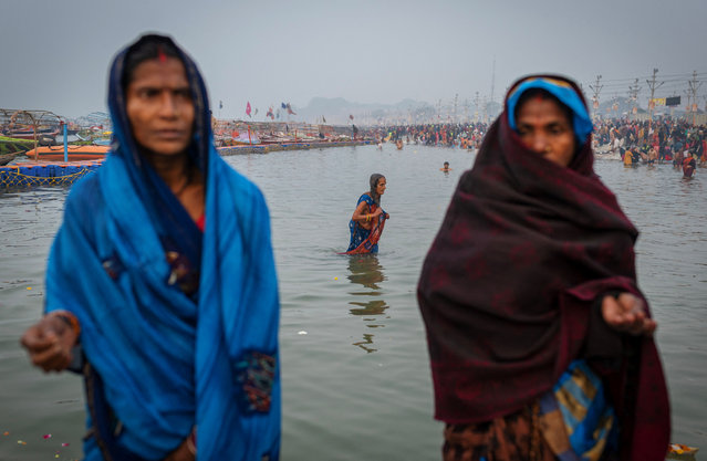Devotees take a holy dip at Sangam, the confluence of the Ganges, Yamuna and Saraswati rivers ahead of the “Maha Kumbh Mela”, or the Pitcher Festival, in Prayagraj, India, on January 12, 2025. (Photo by Adnan Abidi/Reuters)