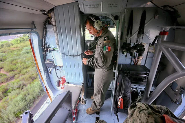 Mexican Navy Pilot Antonio Galvan looks out of a helicopter enroute to the ARM Usumacinta (A-412), during Rim of the Pacific 2016, at Marine Corps Base Camp Pendleton, California, U.S., August 2, 2016. (Photo by Sandy Huffaker/Reuters)