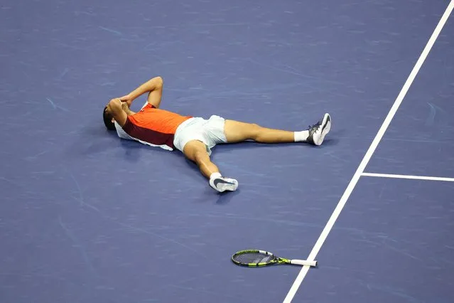 Carlos Alcaraz of Spain falls to the court at match point as he celebrates his victory against Casper Ruud of Norway in the Men's Singles Final match on Arthur Ashe Stadium during the US Open Tennis Championship 2022 at the USTA National Tennis Centre on September 11th 2022 in Flushing, Queens, New York City. (Photo by Shannon Stapleton/Reuters)