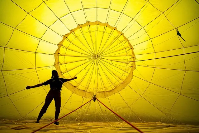 A person checks ropes inside a balloon prior to a flight over Bristol, ahead of the Bristol International Balloon Fiesta 2022 on Monday, August 1, 2022. (Photo by Ben Birchall/PA Images via Getty Images)