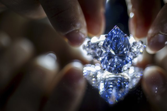 A Christie's employee displays “Bleu Royal”, a rare 17,61 carats internally flawless fancy vivid blue pear shaped diamond, during a preview at the Christie's, in Geneva, Switzerland, Thursday, November 02, 2023. It is estimated to sell between 35 to 50 million USD.The auction will take place in Geneva, on November 07, 2023. (Photo by Martial Trezzini/Keystone vía AP Photo)