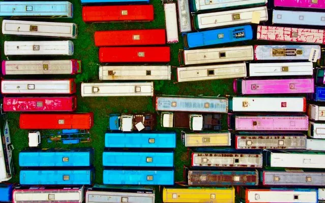 An aerial photo shows retired buses at a recycling plant in Taoyuan, Xinwu district, Taiwan on May 21, 2020. (Photo by Sam Yeh/AFP Photo)