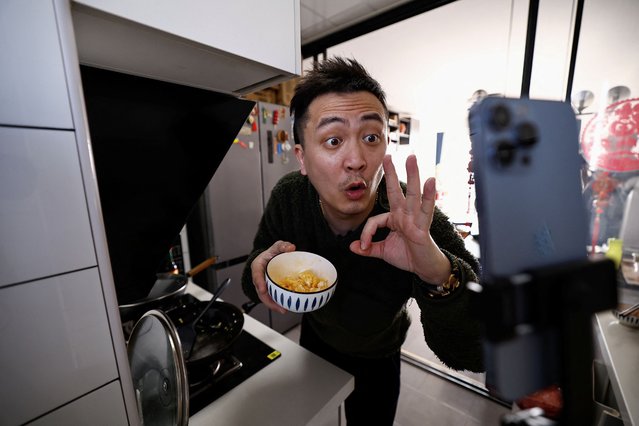 Yu Bo, a content creator on Chinese social media platform Xiaohongshu, also known as RedNote, speaks to his camera as he records a cooking session during an interview with Reuters at his apartment in Beijing, China on February 26, 2025. (Photo by Tingshu Wang/Reuters)