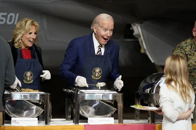 President Joe Biden and first lady Jill Biden react as they serve dinner at Marine Corps Air Station Cherry Point in Havelock, N.C., Monday, November 21, 2022, at a Thanksgiving dinner with members of the military and their families. (Photo by Patrick Semansky/AP Photo)