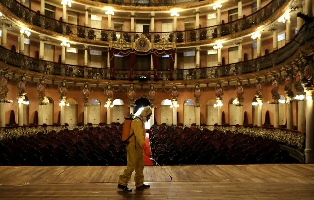 A worker in a protective suit sprays to disinfect the Amazonas Theatre ahead of its reopening after the Amazonas state government eased isolation measures to prevent the spread of the coronavirus disease (COVID-19) in Manaus, Brazil, August 2, 2020. (Photo by Bruno Kelly/Reuters)