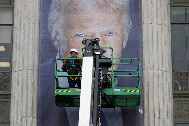 Workers hang an enormous banner of a brooding U.S President Donald Trump alongside a banner of President Abraham Lincoln on the facade of the Department of Agriculture, Jamie L. Whitten Headquarters building, May 14, 2025 in Washington D.C. The banners mark the 163rd anniversary of the agency with what is described as a “North Korean aesthetic”. (Photo by Christophe Paul/Usda/Planet Pix via ZUMA Press Wire/Rex Features/Shutterstock)