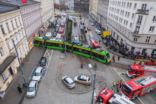 The scene of the tram derailment in Poznan, Poland, 04 Januar 2018. When the driver turned the tram to the stop, the vehicle fell out of the traction and then hit the building. Only one person was injured – the tram driver. (Photo by Pawel Jaskolka/EPA/EFE)