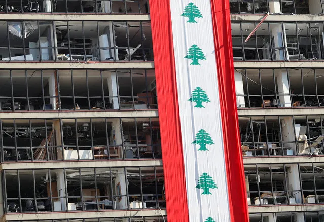 A big Lebanese flag is seen on a damaged building in the aftermath of a massive explosion in Beirut, Lebanon on August 15, 2020. (Photo by Goran Tomasevic/Reuters)