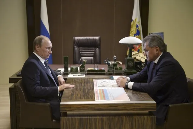 Russian President Vladimir Putin (L) meets with Defence Minister Sergei Shoigu at the Bocharov Ruchei residence in Sochi, Russia, October 7, 2015. Shoigu told Putin during a televised meeting on Wednesday that four Russian warships in the Caspian Sea had launched 26 rockets at Islamic State in Syria. (Photo by Aleksey Nikolskyi/Reuters/RIA Novosti/Kremlin)