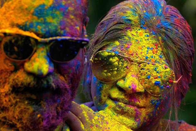 Faces of a couple are smeared with colored powder as they celebrate Holi, the Hindu festival of colors, in Mumbai, India, Monday, March 25, 2024. (Photo by Rafiq Maqbool/AP Photo)