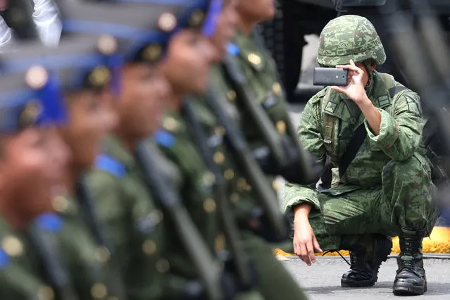 A soldier takes photos with mobile phone during a military parade celebrating Independence Day at Zocalo Square in downtown Mexico City, Mexico, September 16, 2016. (Photo by Edgard Garrido/Reuters)