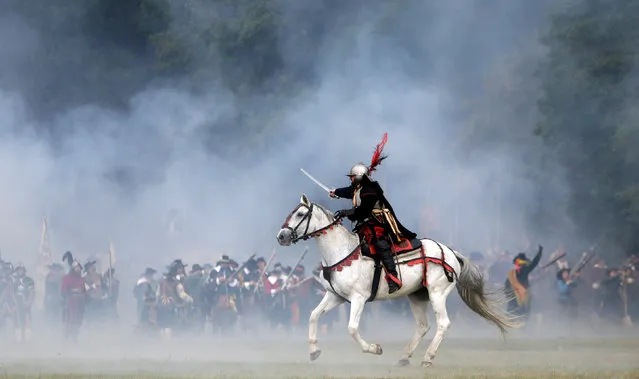 Participants wearing medieval costumes re-enact the 1620 battle of Bila Hora between Bohemian Estates and Austrian Imperial with Catholic forces in Prague, Czech Republic September 18, 2016. (Photo by David W. Cerny/Reuters)